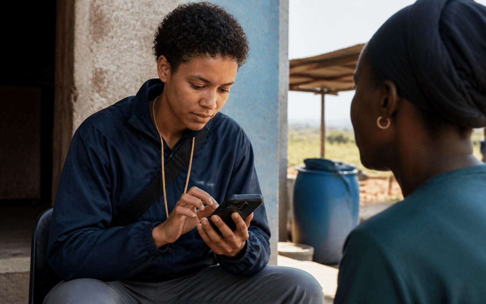Field researcher collecting survey data with a mobile device